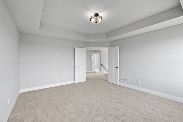 empty room with light carpet, baseboards, and visible vents