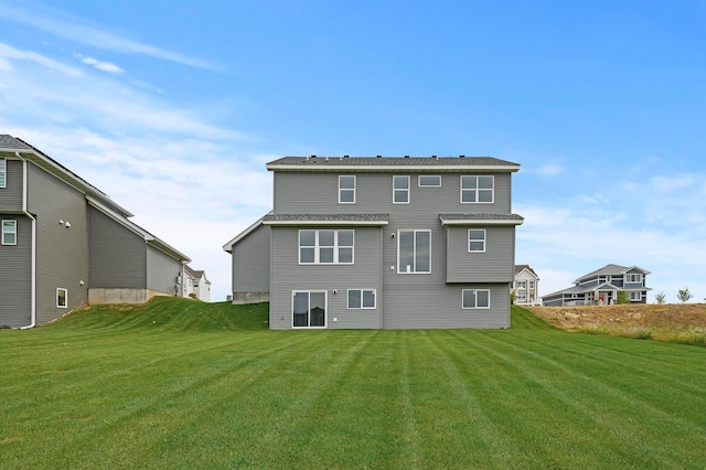 back of house with a lawn