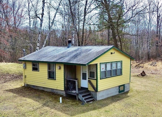 357 Glenmar Dr NE, Longville, MN 56655 - exterior space with roof with shingles, a front yard, crawl space, and a view of trees