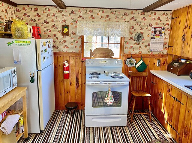 357 Glenmar Dr NE, Longville, MN 56655 - kitchen featuring brown cabinetry, wainscoting, wood walls, white appliances, and wallpapered walls