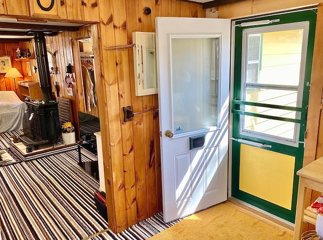 357 Glenmar Dr NE, Longville, MN 56655 - interior space with wooden walls, a wood stove, and light carpet