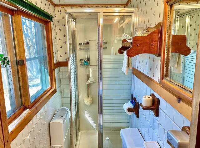 357 Glenmar Dr NE, Longville, MN 56655 - full bathroom featuring tile walls, wallpapered walls, and a stall shower