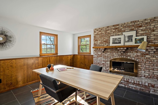 5 Shore Rd, North Oaks, MN 55127 - office featuring dark tile patterned floors, wainscoting, wood walls, and a brick fireplace