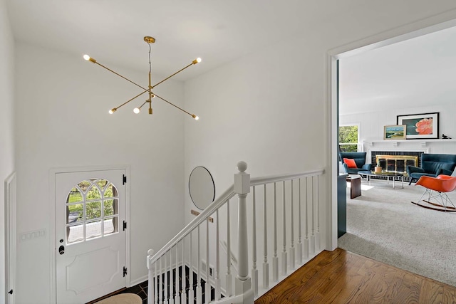 5 Shore Rd, North Oaks, MN 55127 - entrance foyer with plenty of natural light, a chandelier, wood finished floors, a brick fireplace, and a high ceiling