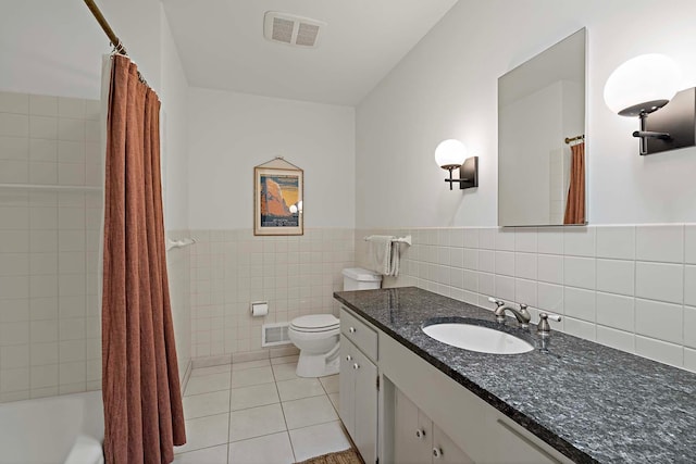 5 Shore Rd, North Oaks, MN 55127 - bathroom with vanity, tile patterned flooring, tile walls, toilet, and wainscoting