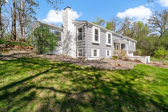 5 Shore Rd, North Oaks, MN 55127 - rear view of house with a chimney and a lawn