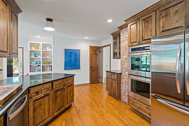 5 Shore Rd, North Oaks, MN 55127 - kitchen featuring stainless steel appliances, light wood-type flooring, recessed lighting, dark stone counters, and glass insert cabinets