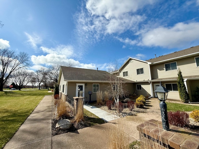 1513 Creek Meadows Dr NW, Coon Rapids, MN 55433 - view of front of home featuring a front lawn and roof with shingles