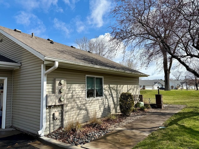 1513 Creek Meadows Dr NW, Coon Rapids, MN 55433 - view of side of home with a shingled roof and a yard