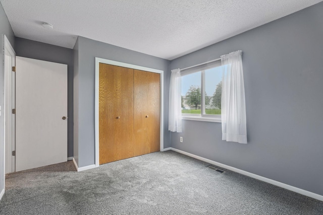 1513 Creek Meadows Dr NW, Coon Rapids, MN 55433 - unfurnished bedroom with carpet flooring, a closet, and a textured ceiling