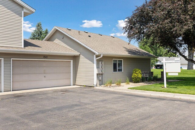 1513 Creek Meadows Dr NW, Coon Rapids, MN 55433 - view of front facade with roof with shingles, driveway, and a garage