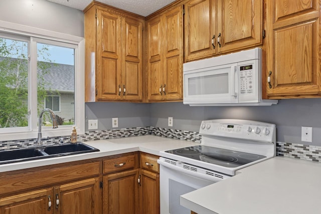 1513 Creek Meadows Dr NW, Coon Rapids, MN 55433 - kitchen with white appliances, light countertops, brown cabinets, and tasteful backsplash