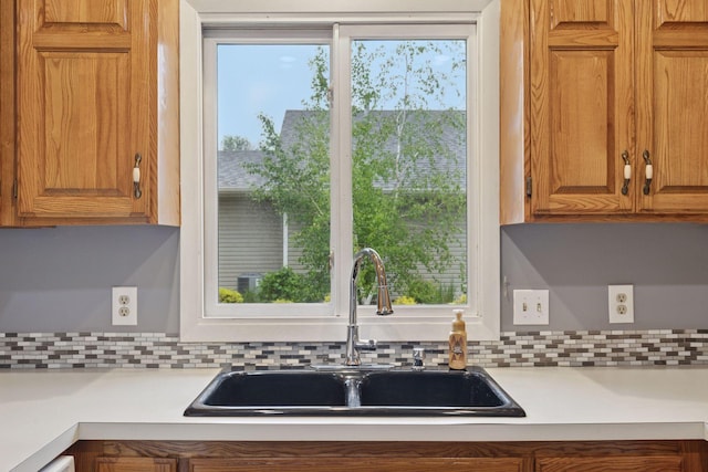 1513 Creek Meadows Dr NW, Coon Rapids, MN 55433 - kitchen with light countertops, tasteful backsplash, and brown cabinetry