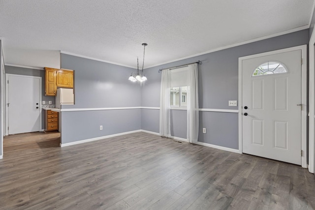 1513 Creek Meadows Dr NW, Coon Rapids, MN 55433 - foyer featuring a chandelier, a textured ceiling, plenty of natural light, crown molding, and dark wood-style floors