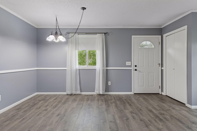 1513 Creek Meadows Dr NW, Coon Rapids, MN 55433 - entrance foyer featuring plenty of natural light, a chandelier, crown molding, wood finished floors, and a textured ceiling