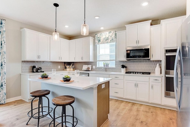 528 Goldenrod Trl, Waconia, MN 55387 - kitchen featuring stainless steel appliances, light wood finished floors, white cabinets, light countertops, and recessed lighting