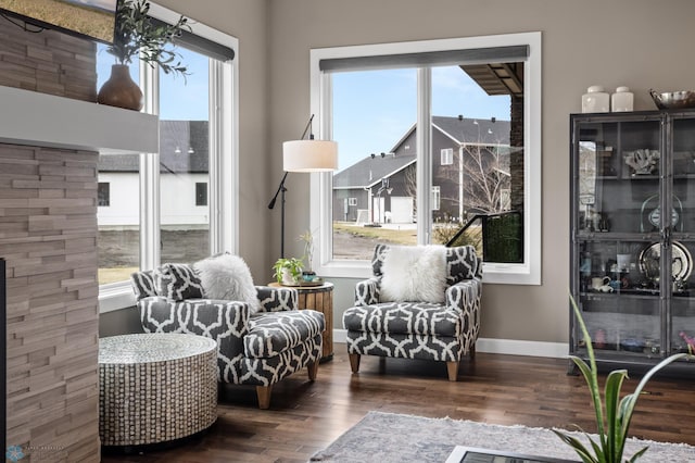 living area with wood finished floors and baseboards