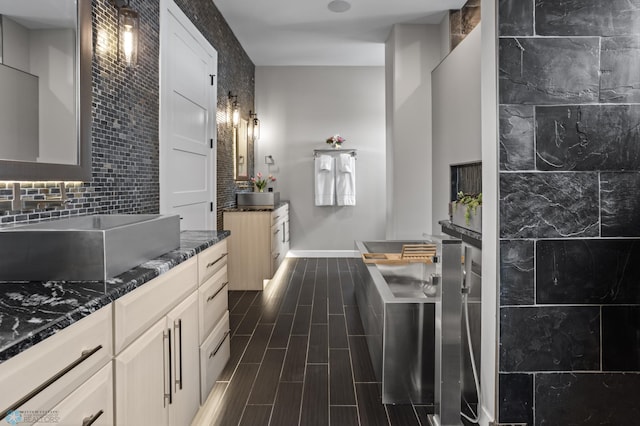 full bathroom featuring baseboards, tasteful backsplash, two vanities, and wood tiled floors