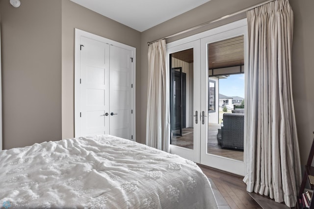 bedroom with french doors, access to outside, dark wood finished floors, and a closet