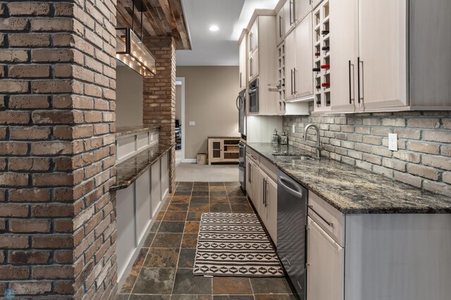 kitchen with stainless steel dishwasher, a sink, stone tile floors, open shelves, and baseboards