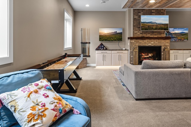 carpeted living area with a fireplace, recessed lighting, and baseboards