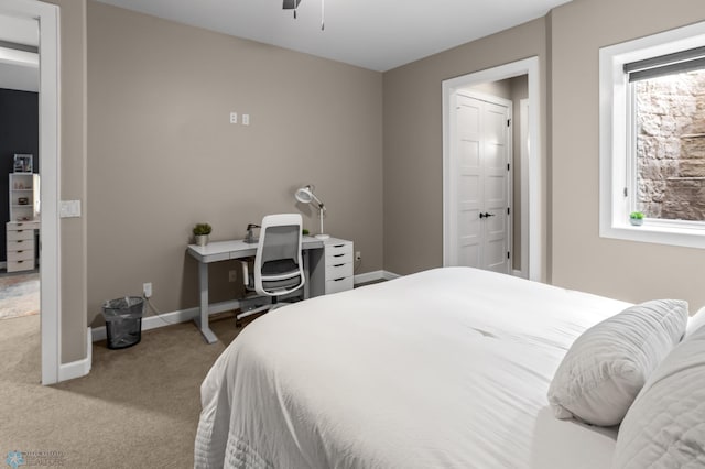 bedroom with carpet, baseboards, and ensuite bathroom