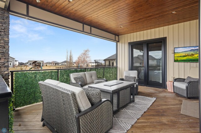 wooden terrace featuring an outdoor living space