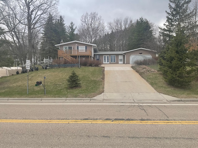 36074 County Highway 72, Everts Twp, MN 56515 - split level home featuring an attached garage, driveway, a wooden deck, and a front yard