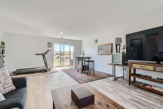 living room with baseboards and wood finished floors