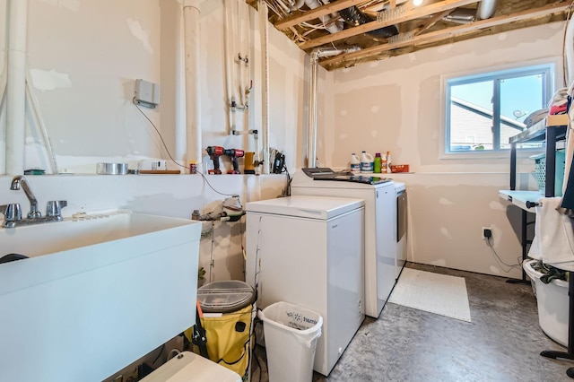 washroom with separate washer and dryer and a sink