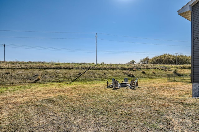 view of yard featuring a fire pit and a rural view
