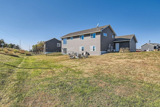 back of property featuring a yard