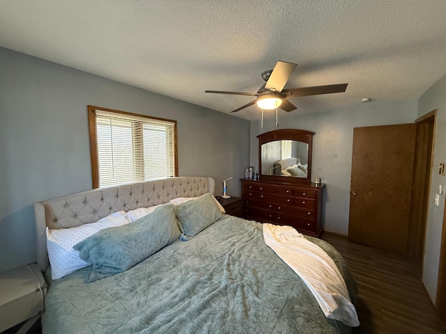 bedroom featuring a textured ceiling, ceiling fan, and wood finished floors