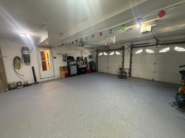garage with a garage door opener and a central vacuum unit