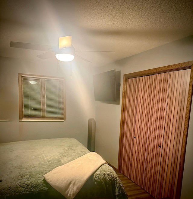 bedroom with ceiling fan and wood finished floors