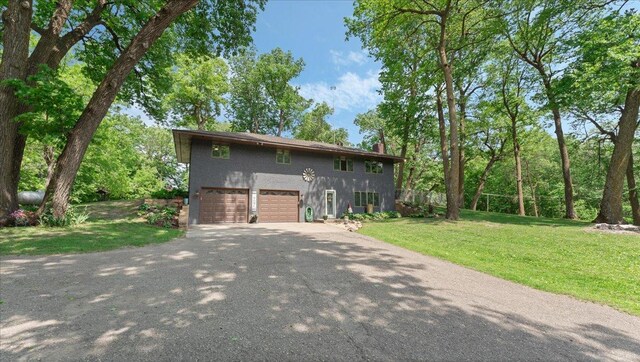19593 Minnesota Highway 22, Greenleaf Twp, MN 55355 - view of front of property featuring asphalt driveway, stucco siding, an attached garage, a front lawn, and a chimney