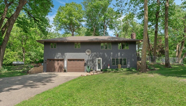 19593 Minnesota Highway 22, Greenleaf Twp, MN 55355 - view of front of home with asphalt driveway, a chimney, an attached garage, and stucco siding