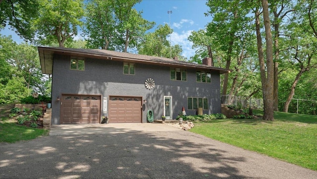 19593 Minnesota Highway 22, Greenleaf Twp, MN 55355 - view of front of house featuring stucco siding, asphalt driveway, a chimney, an attached garage, and a front lawn