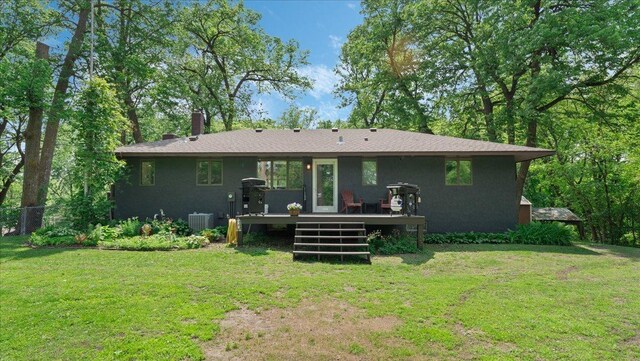 19593 Minnesota Highway 22, Greenleaf Twp, MN 55355 - back of property with a deck, a lawn, central air condition unit, and a chimney