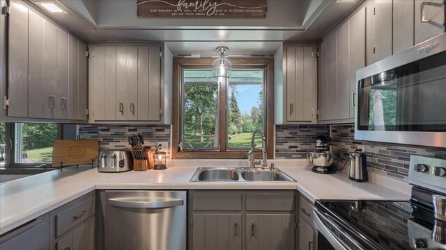 19593 Minnesota Highway 22, Greenleaf Twp, MN 55355 - kitchen featuring appliances with stainless steel finishes, gray cabinets, a sink, and backsplash