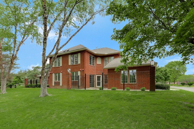 13409 44th Cir NE, Saint Michael, MN 55376 - rear view of property with a yard, brick siding, and roof with shingles