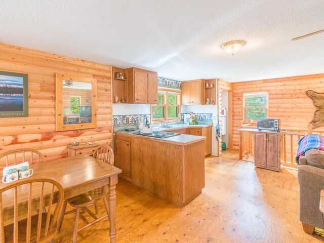 10823 Bollenbacher Rd, Garrison Twp, MN 56401 - kitchen with open shelves, light wood-type flooring, a peninsula, a textured ceiling, and log walls
