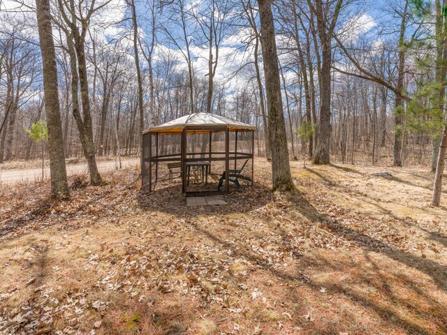 10823 Bollenbacher Rd, Garrison Twp, MN 56401 - view of yard featuring a gazebo and a wooded view