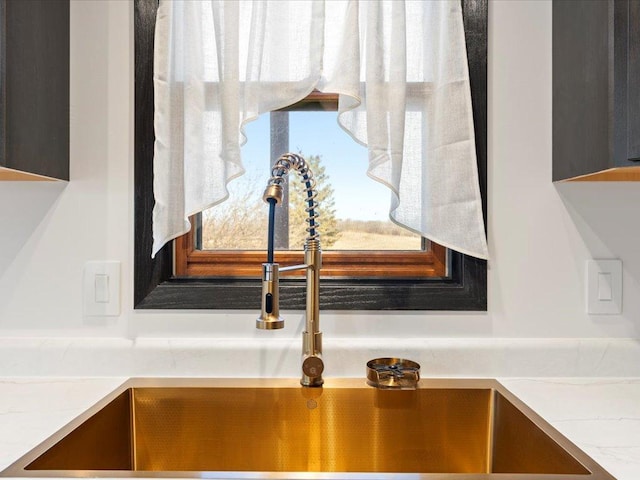 kitchen view of a sink and light countertops