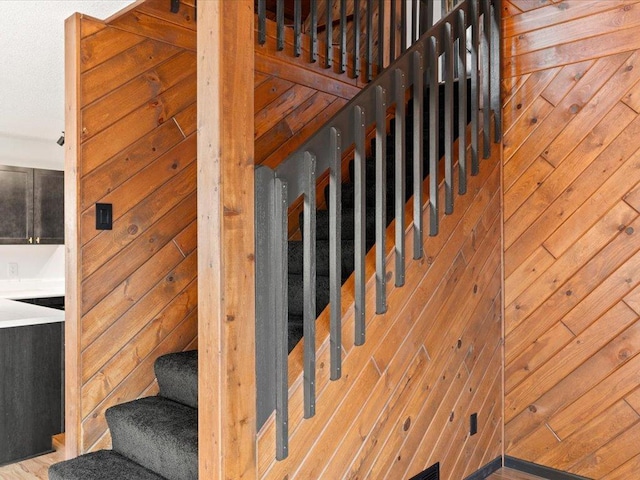 staircase with wood walls