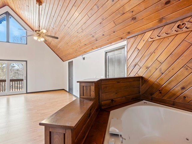 bathroom with wood ceiling, ceiling fan, a tub with jets, high vaulted ceiling, and wood finished floors