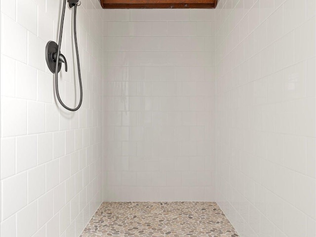 full bath with a tile shower