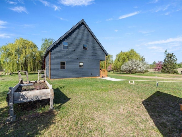 view of home's exterior featuring a yard and a garden