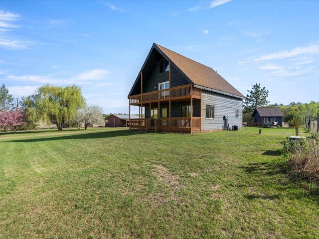 back of house featuring a lawn and a deck