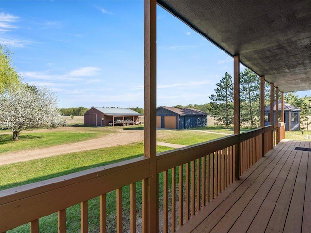 wooden deck featuring a yard and an outdoor structure